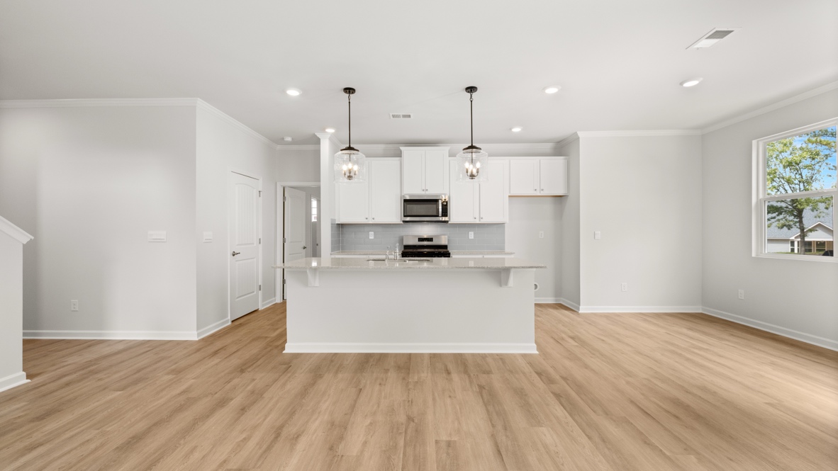 Interior kitchen with center island and white cabinets