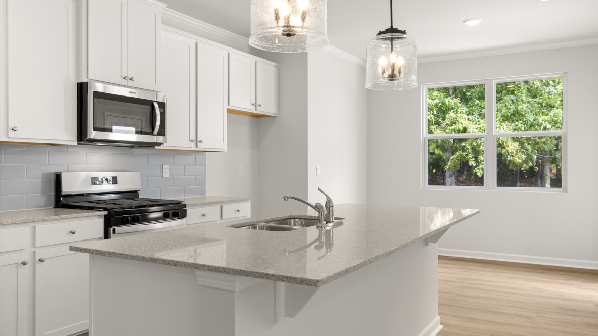 Interior kitchen with center island and white cabinets