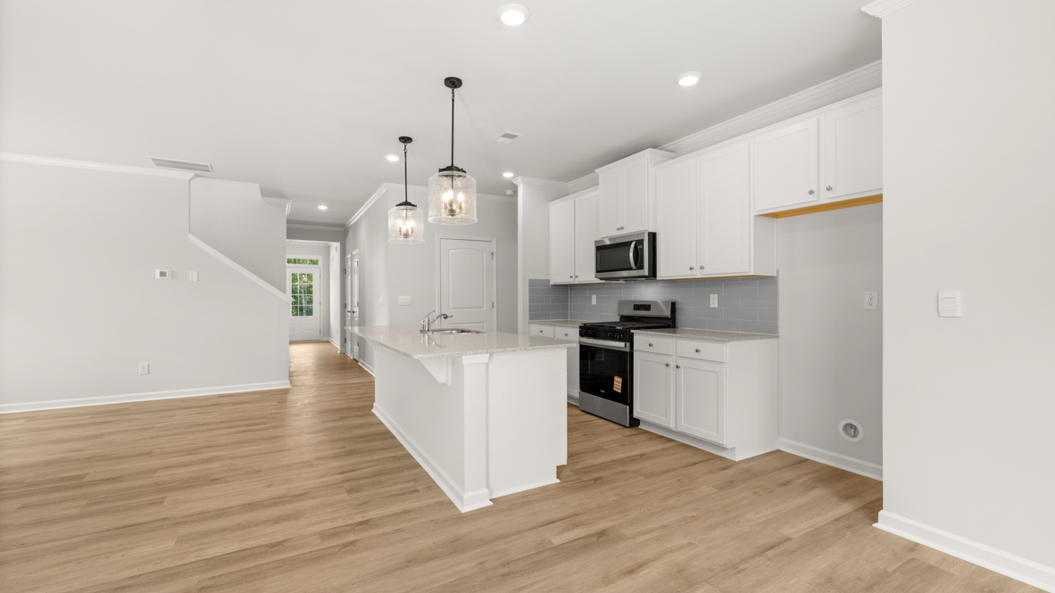 Interior kitchen with center island and white cabinets