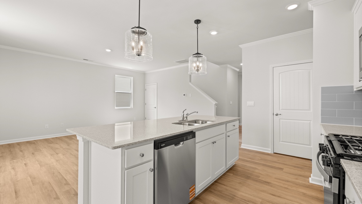 Interior kitchen with center island and white cabinets