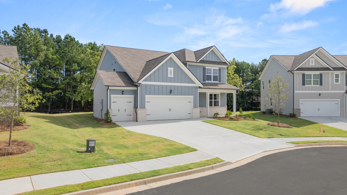 Exterior two-story home with light blue cladding and stone detailing