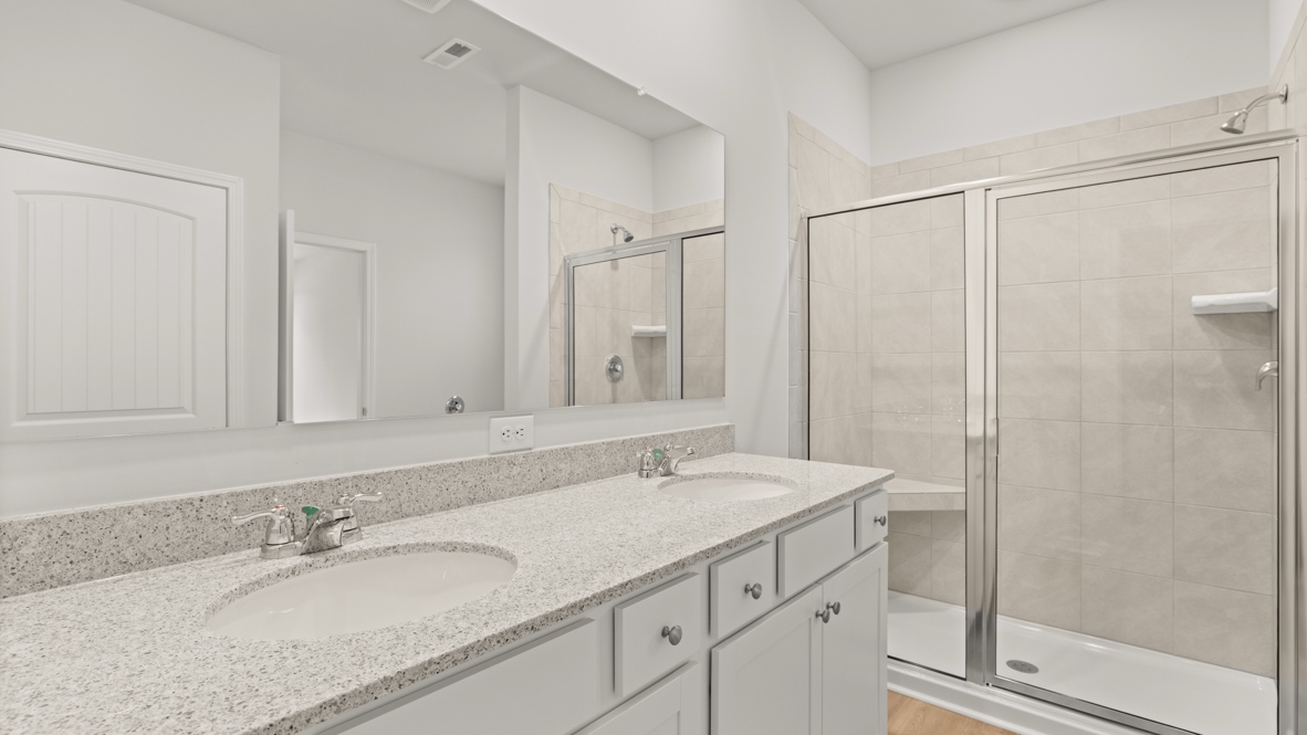 Interior primary bathroom with double sink and shower