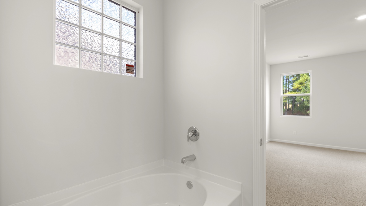 Interior primary bathroom with bath tub