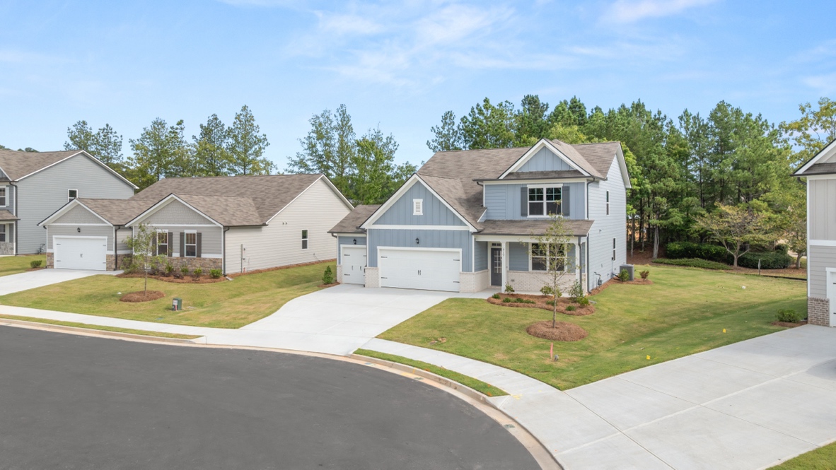 Exterior two-story home with light blue cladding and stone detailing