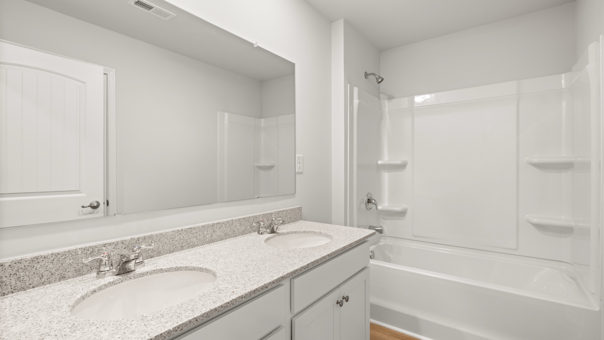 Interior bathroom with double sink and full-sized shower