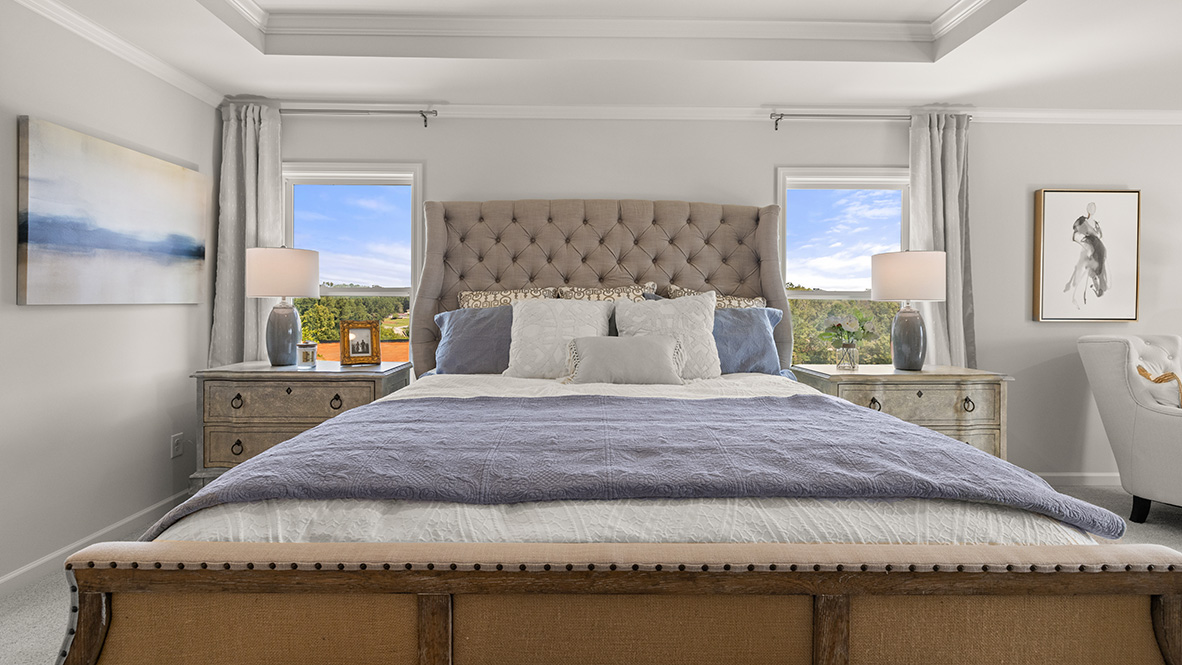 Interior primary bedroom with large windows