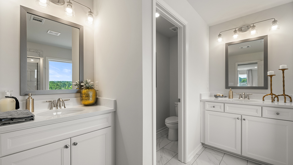 Interior primary bathroom with two sinks, bath tub and shower