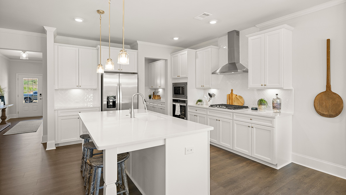Interior kitchen with center island and white cabinets