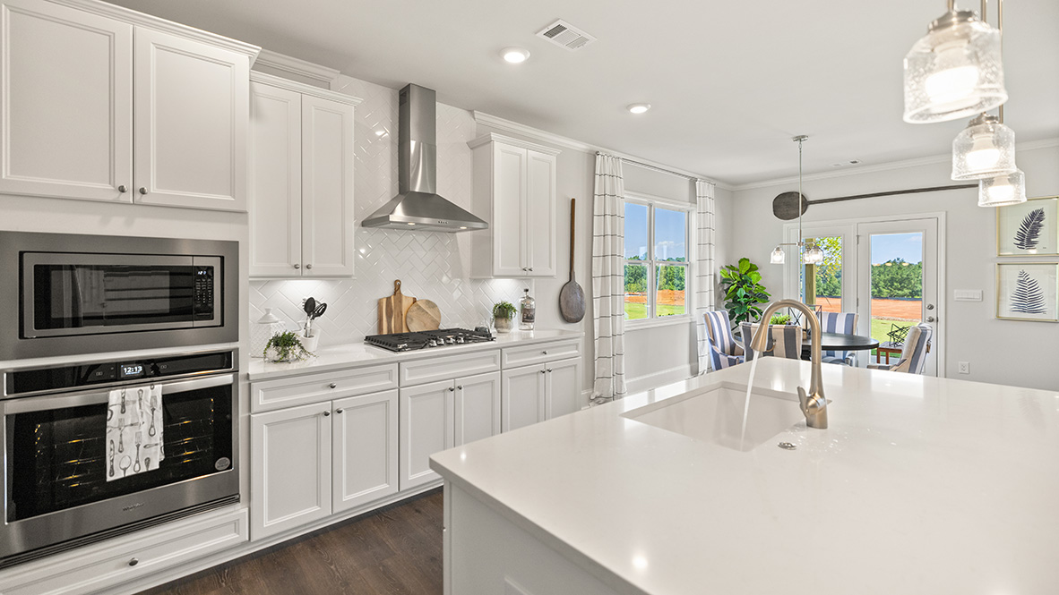 Interior kitchen with center island and white cabinets