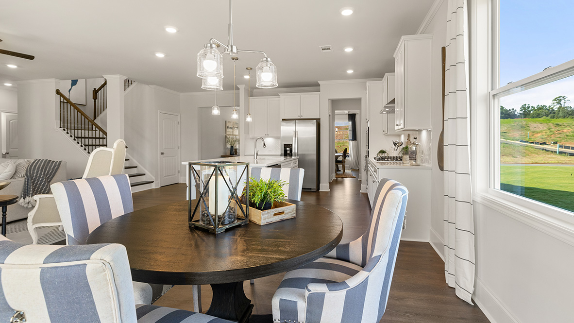 Interior dining area in kitchen next to large window