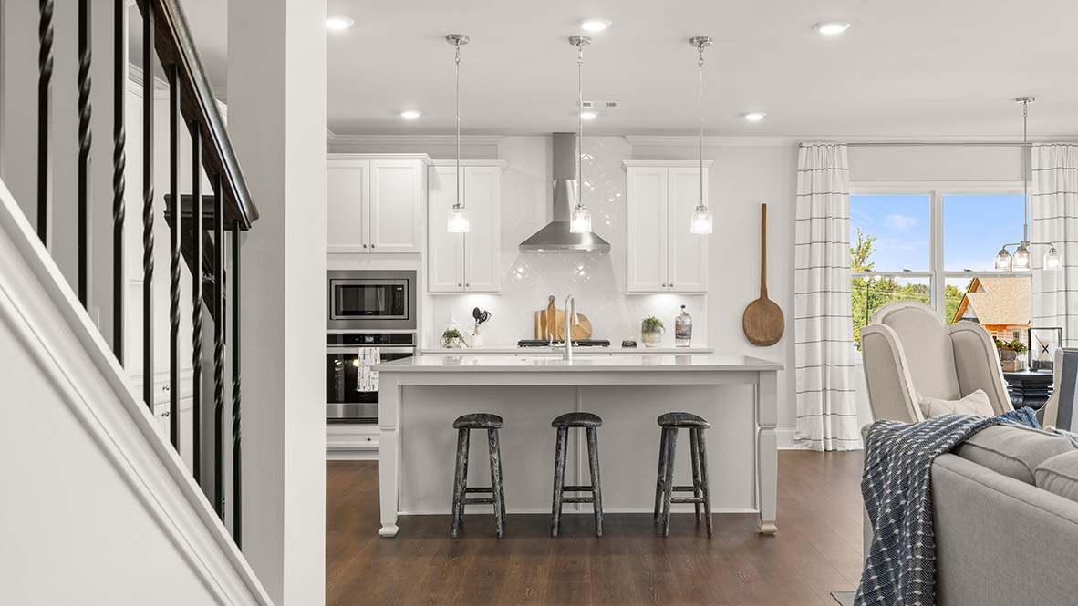 Interior kitchen with center island and white cabinets