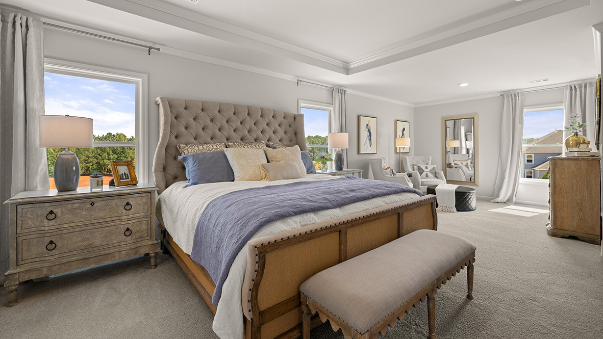 Interior primary bedroom with large windows