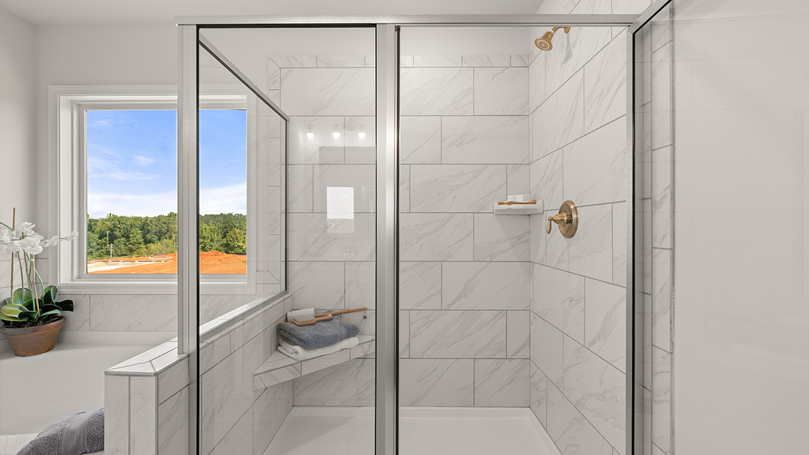Interior primary bathroom with bath tub and shower