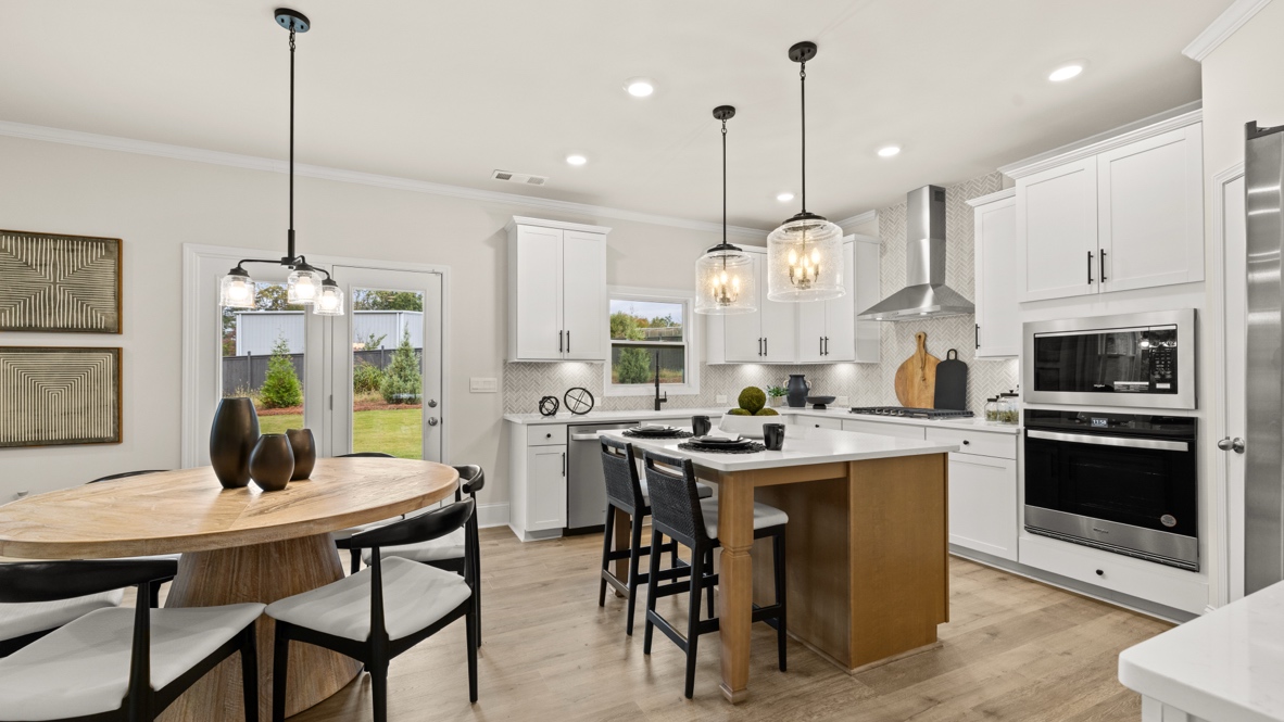 Interior kitchen with center island and white cabinets