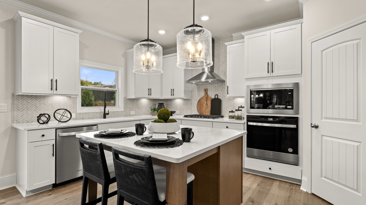 Interior kitchen with center island and white cabinets