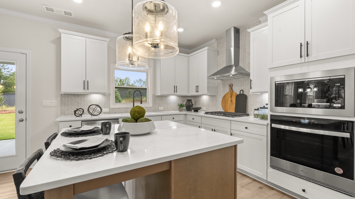 Interior kitchen with center island and white cabinets
