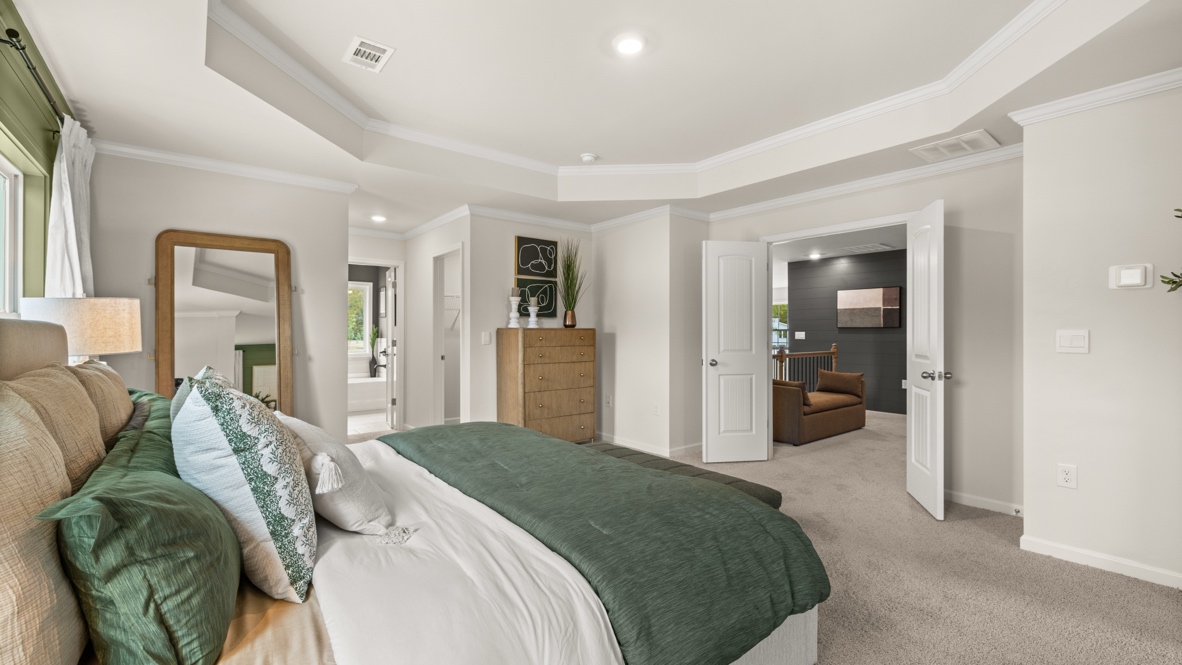Interior primary bedroom with large windows and accent wall