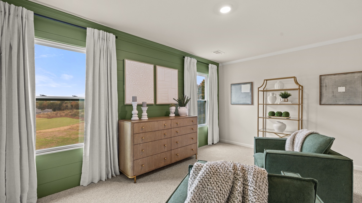 Interior primary bedroom with large windows and accent wall