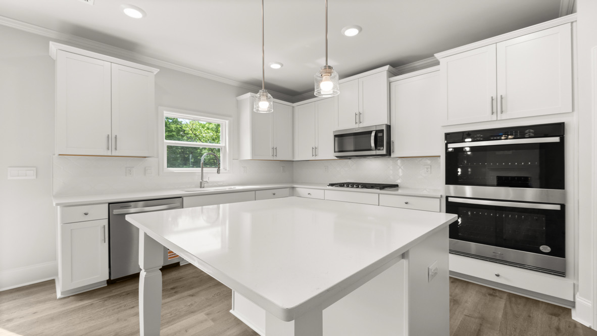 Interior kitchen with center island and white cabinets