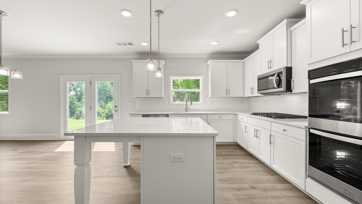 Interior kitchen with center island and white cabinets