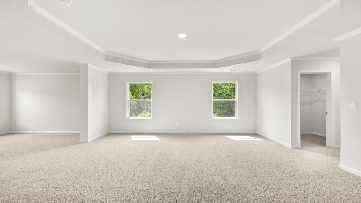 Interior primary bedroom with windows