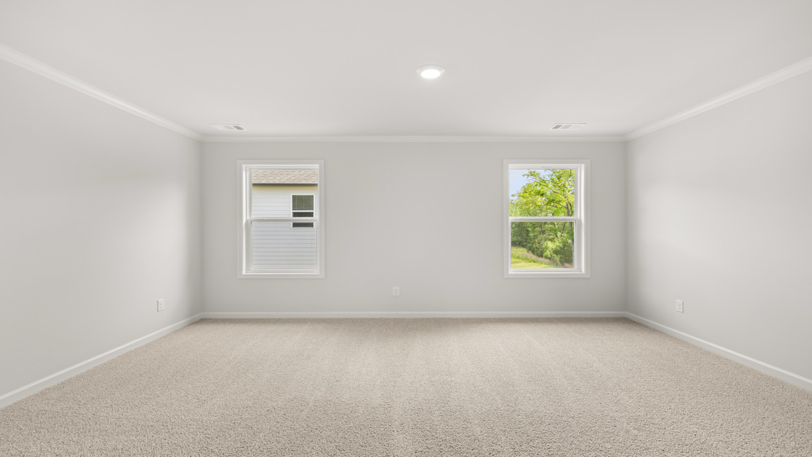 Interior primary bedroom with windows