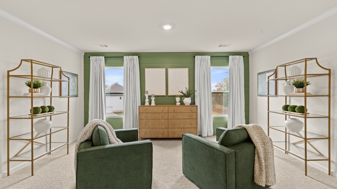 Interior primary bedroom with accent wall and windows