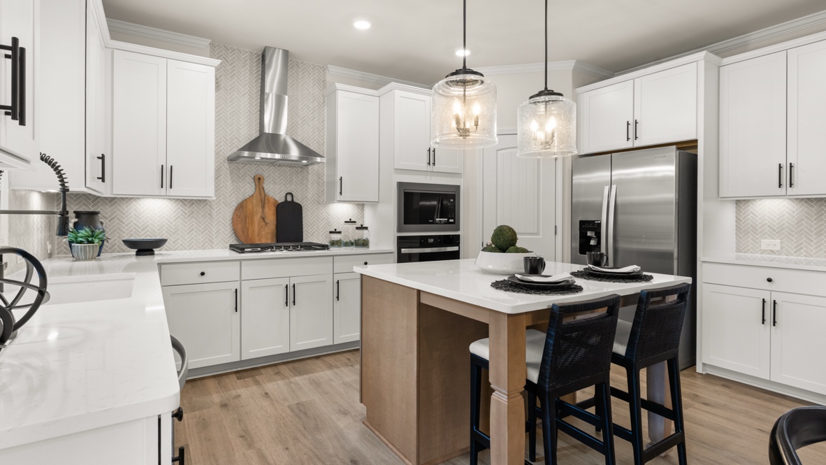 Interior kitchen with center island and white cabinets