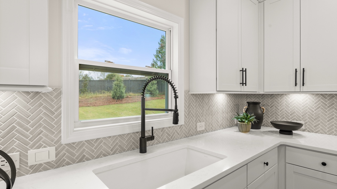 Interior kitchen with center island and white cabinets