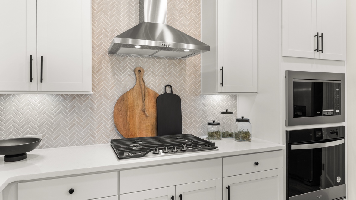 Interior kitchen with center island and white cabinets