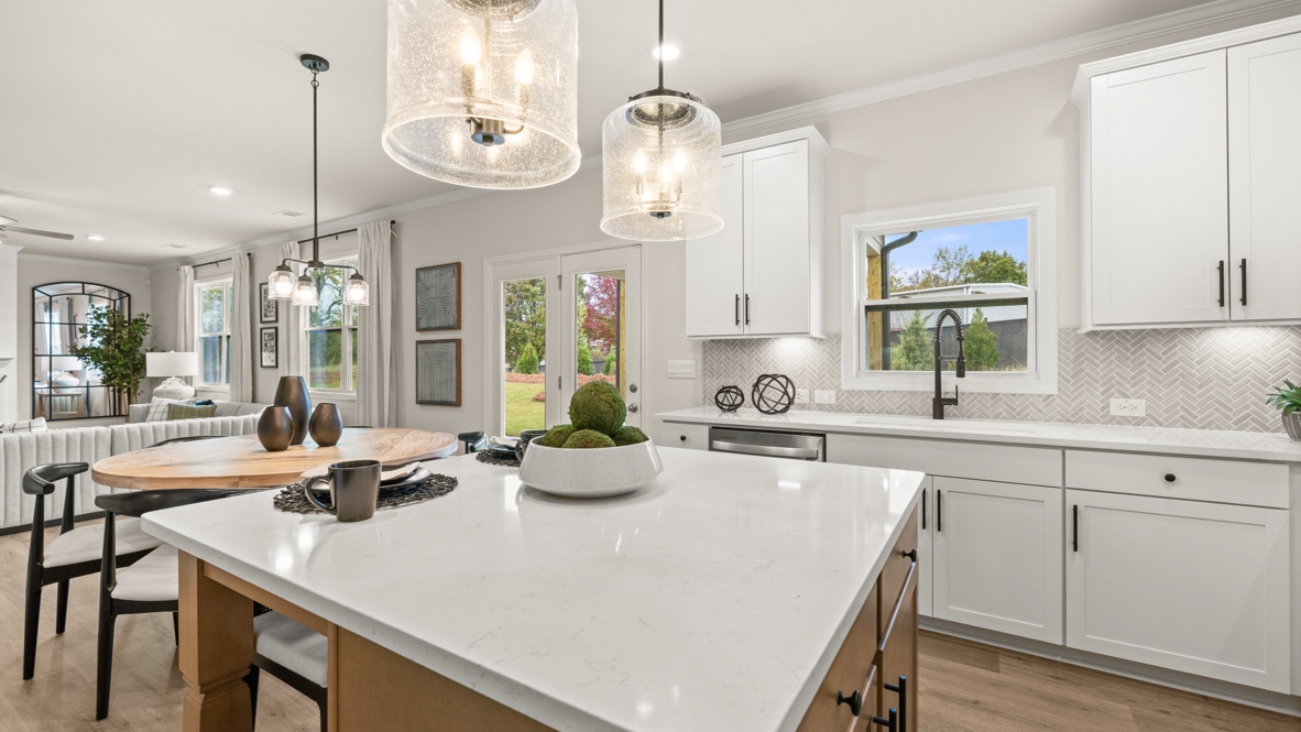 Interior kitchen with center island and white cabinets