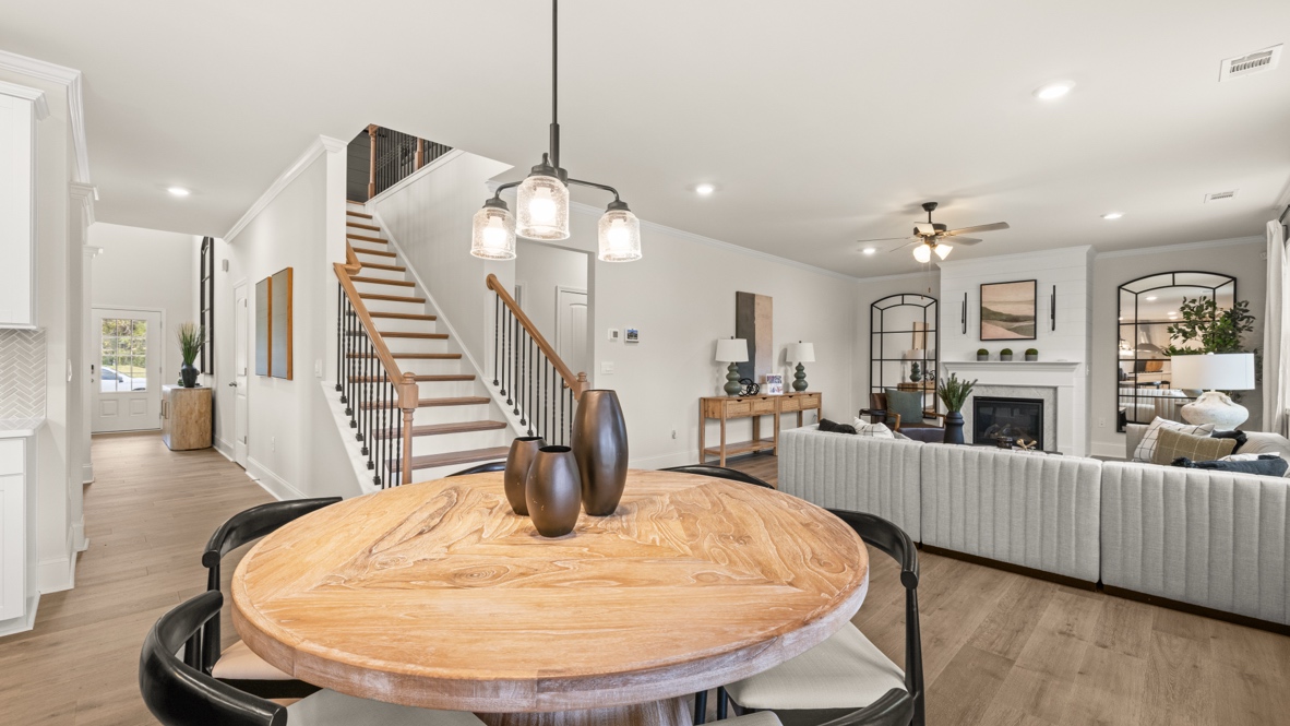 Interior dining area open to kitchen and staircase