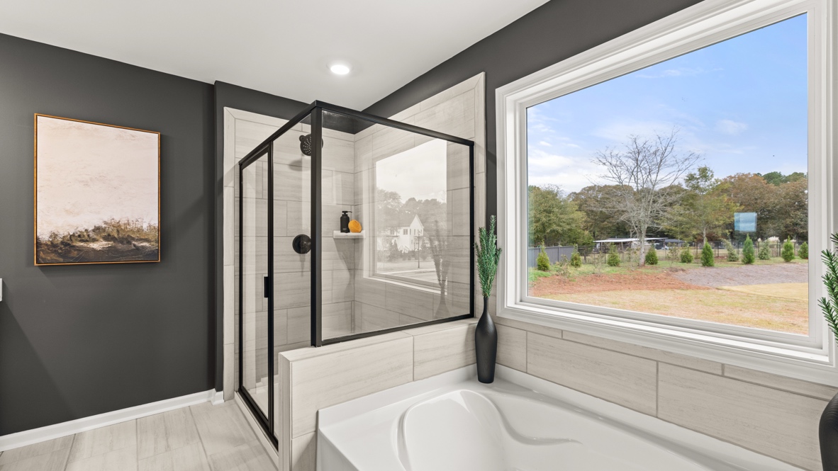Interior primary bathroom with shower and bath tub