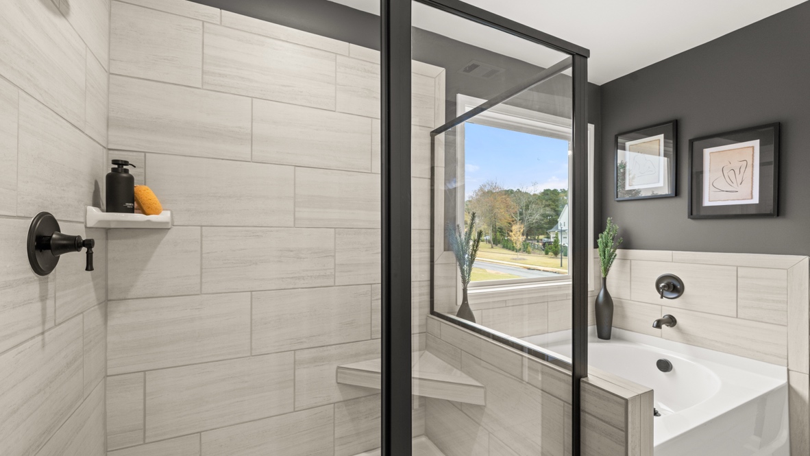 Interior primary bathroom with shower and bath tub
