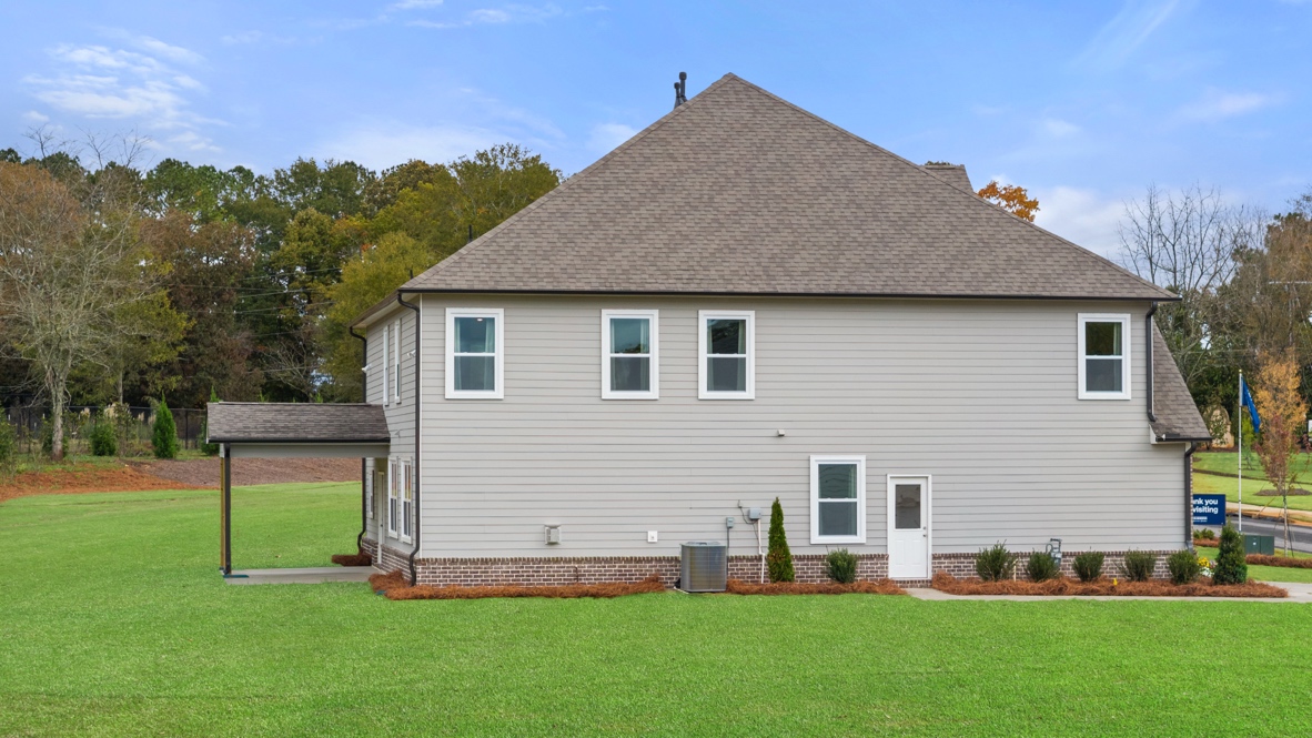 Exterior rear view of home with back yard