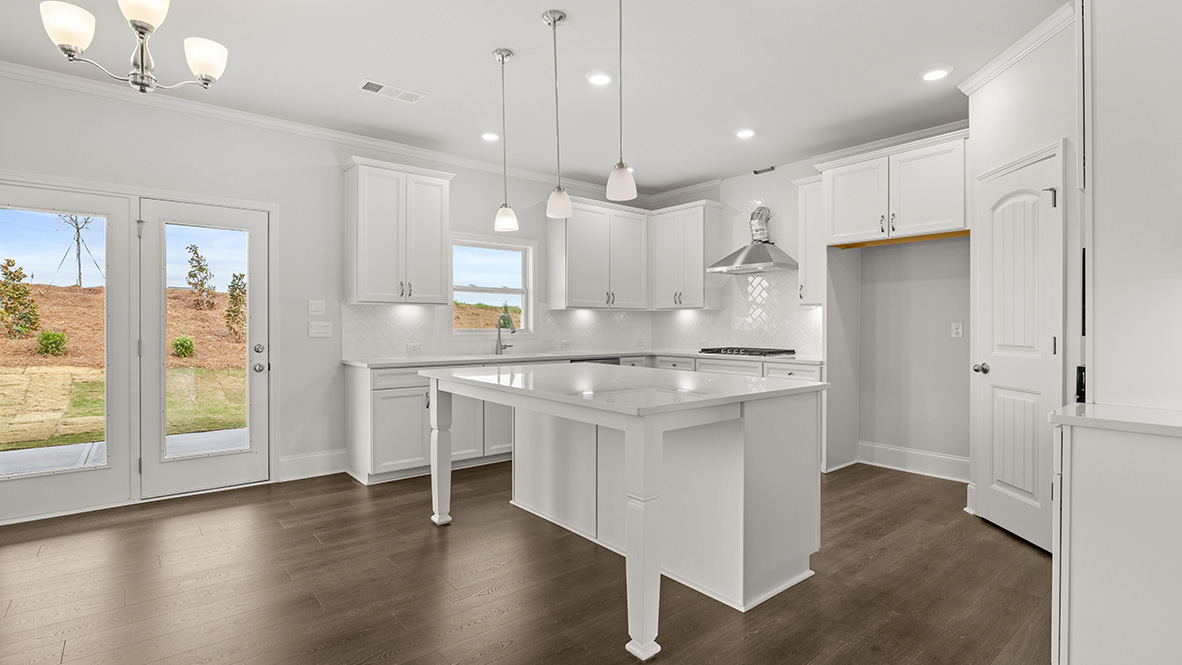Interior kitchen with center island and white cabinets