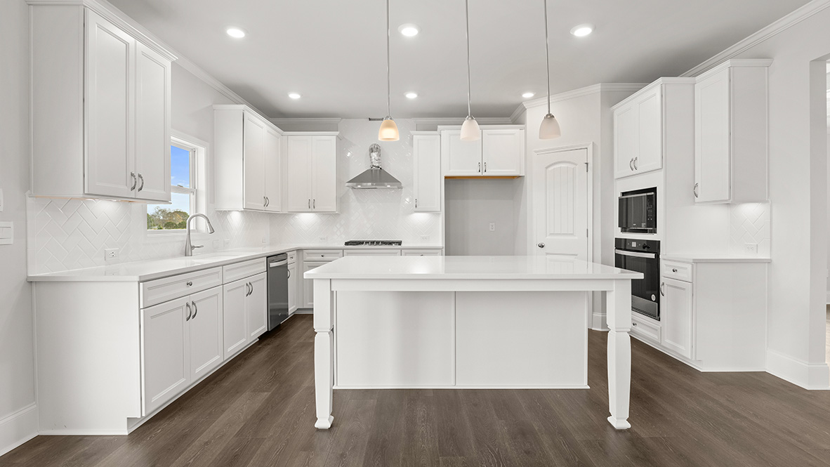 Interior kitchen with center island and white cabinets