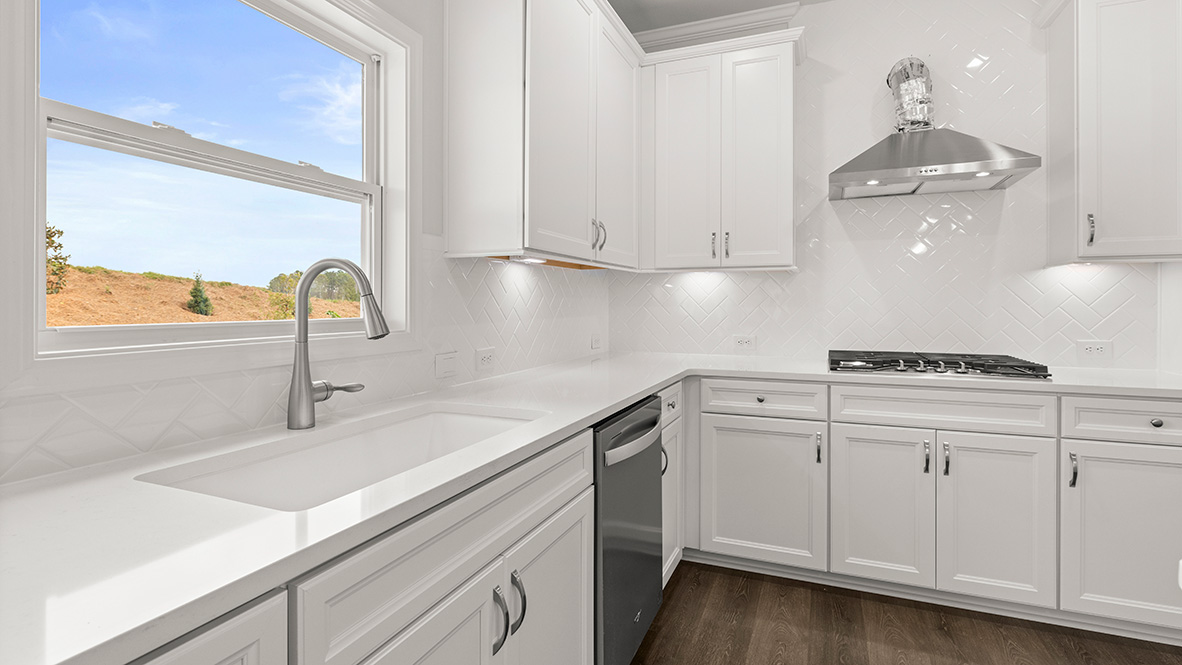 Interior kitchen with center island and white cabinets