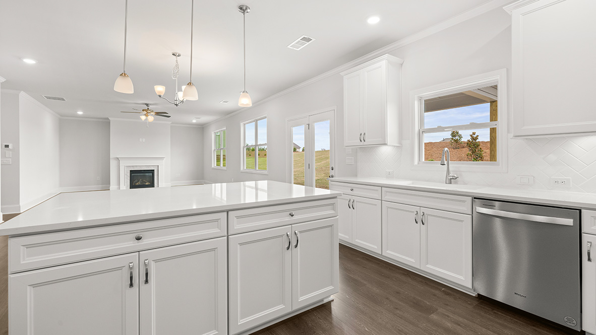 Interior kitchen with center island and white cabinets