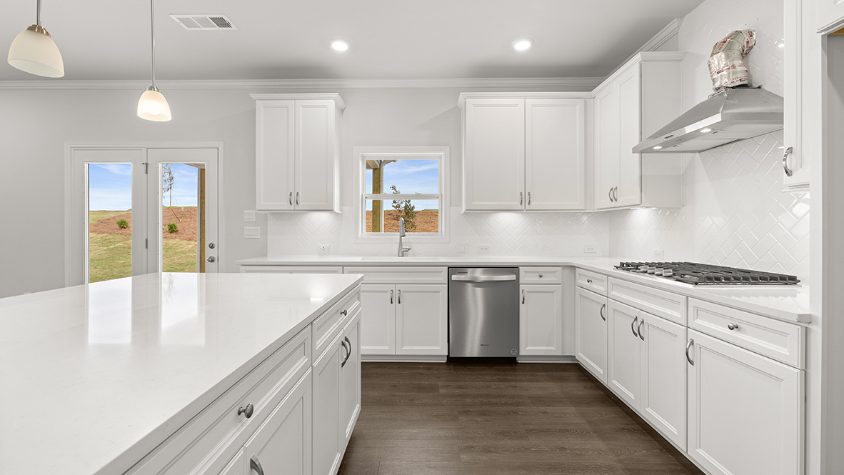 Interior kitchen with center island and white cabinets