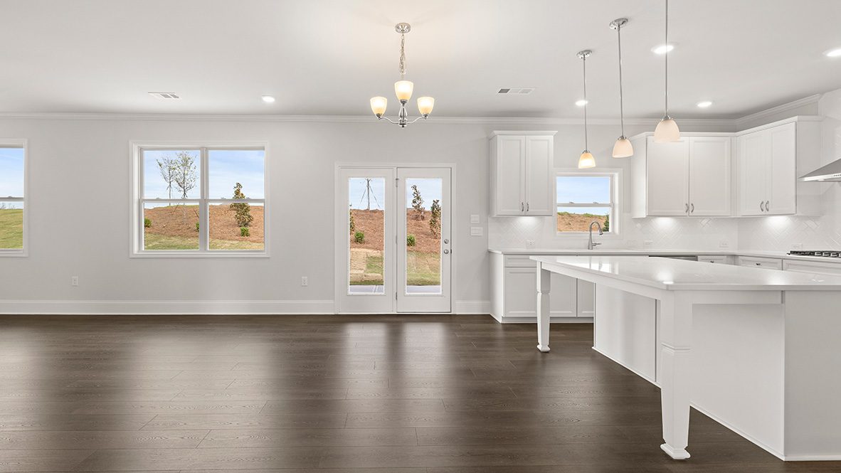 Interior kitchen with center island and white cabinets