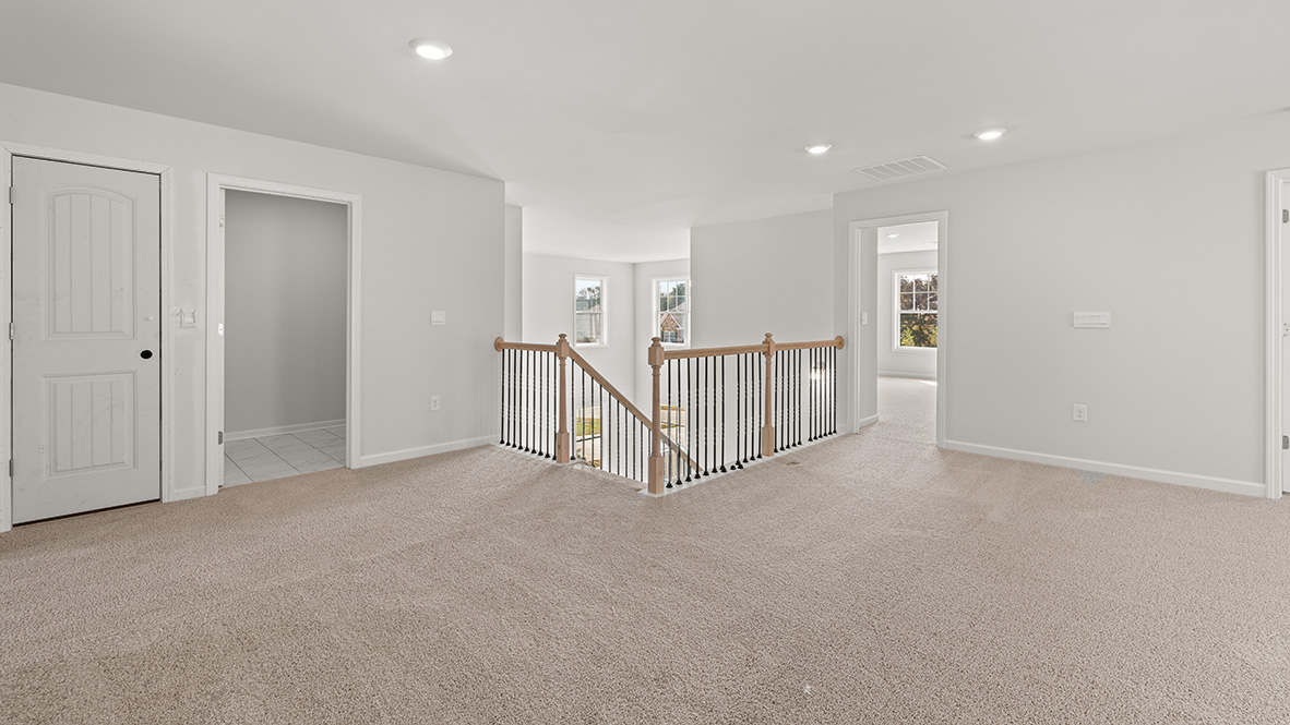 Interior upstairs loft area open to staircase