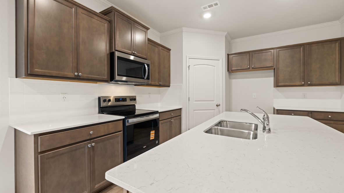 Interior kitchen with center island and wooden cabinets