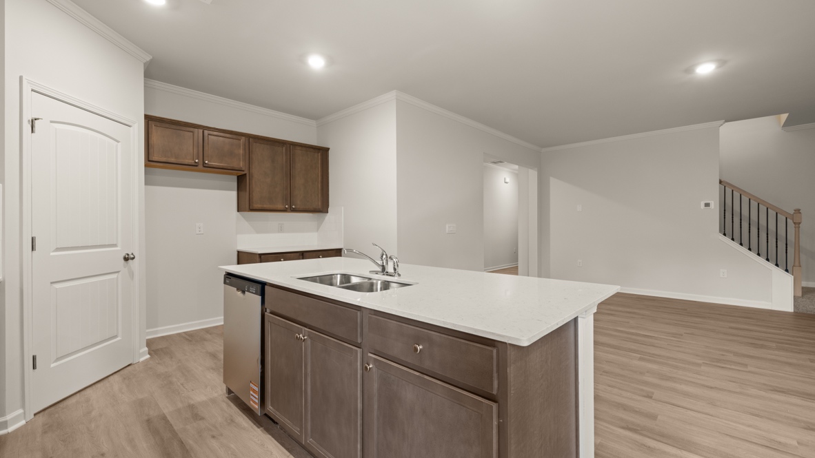 Interior kitchen with center island and wooden cabinets