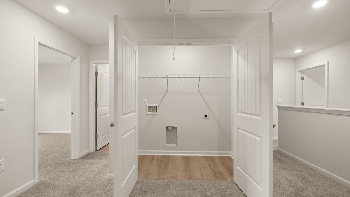 Interior upstairs loft area with laundry room