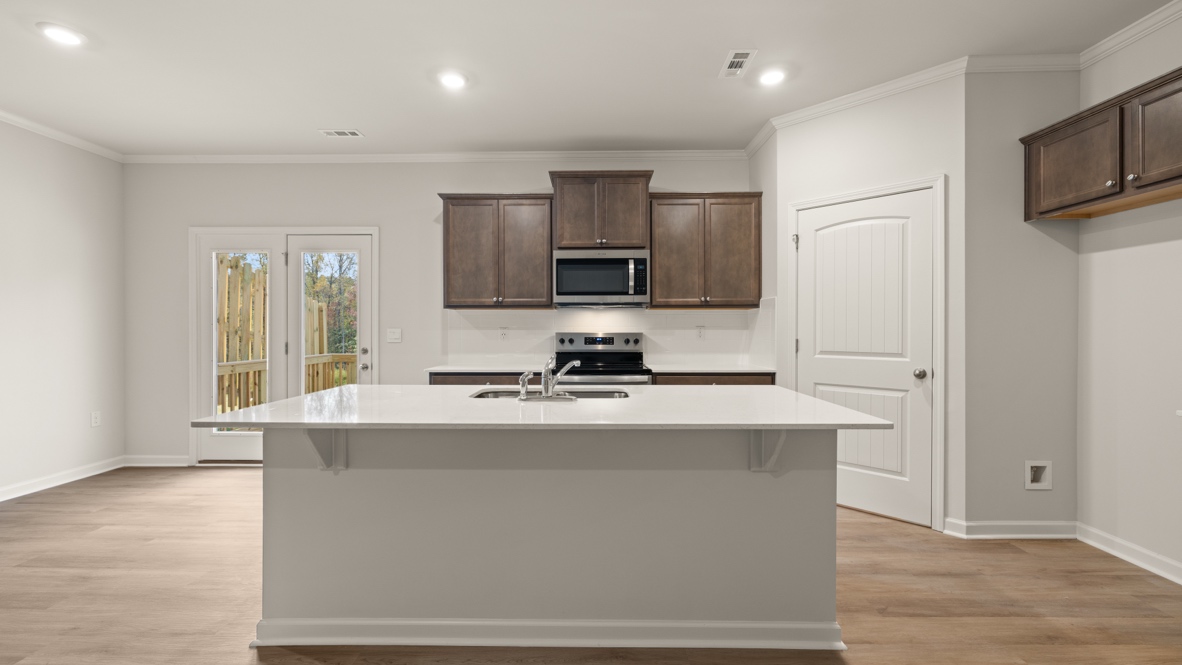 Interior kitchen with center island and wooden cabinets