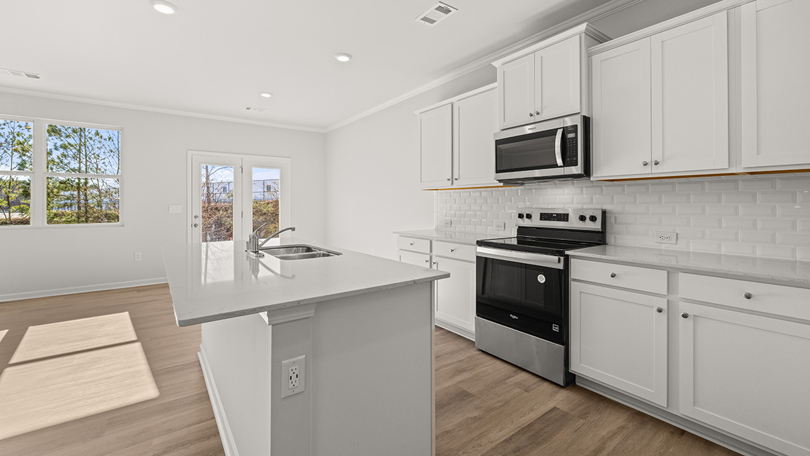 Interior kitchen with center island and white cabinets