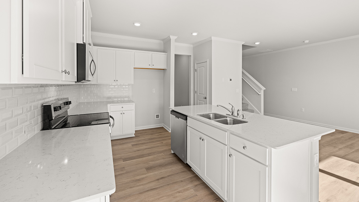 Interior kitchen with center island and white cabinets