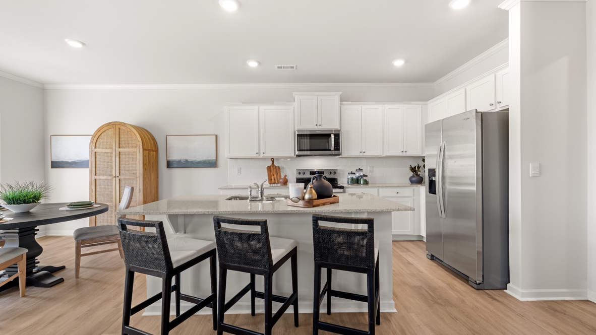 Interior kitchen with center island and white cabinets