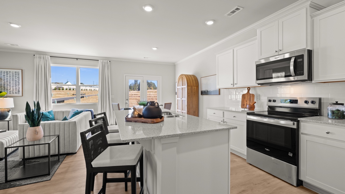 Interior kitchen with center island and white cabinets